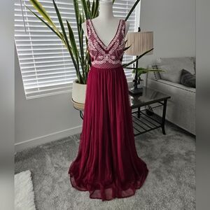 Royaal Share Love Stunning burgundy gown featuring an intricate bodice design. P